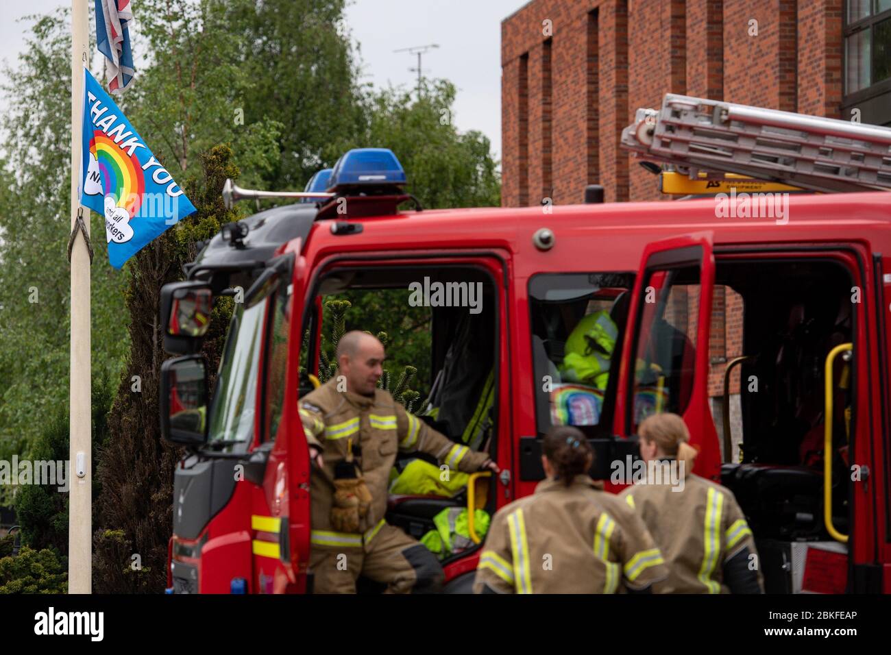 Flags are flown at half mast as firefighters observe a minute's silence outside Bournbrook Community fire station in Birmingham, in memory of their colleagues that lost their lives in the line of duty. Stock Photo