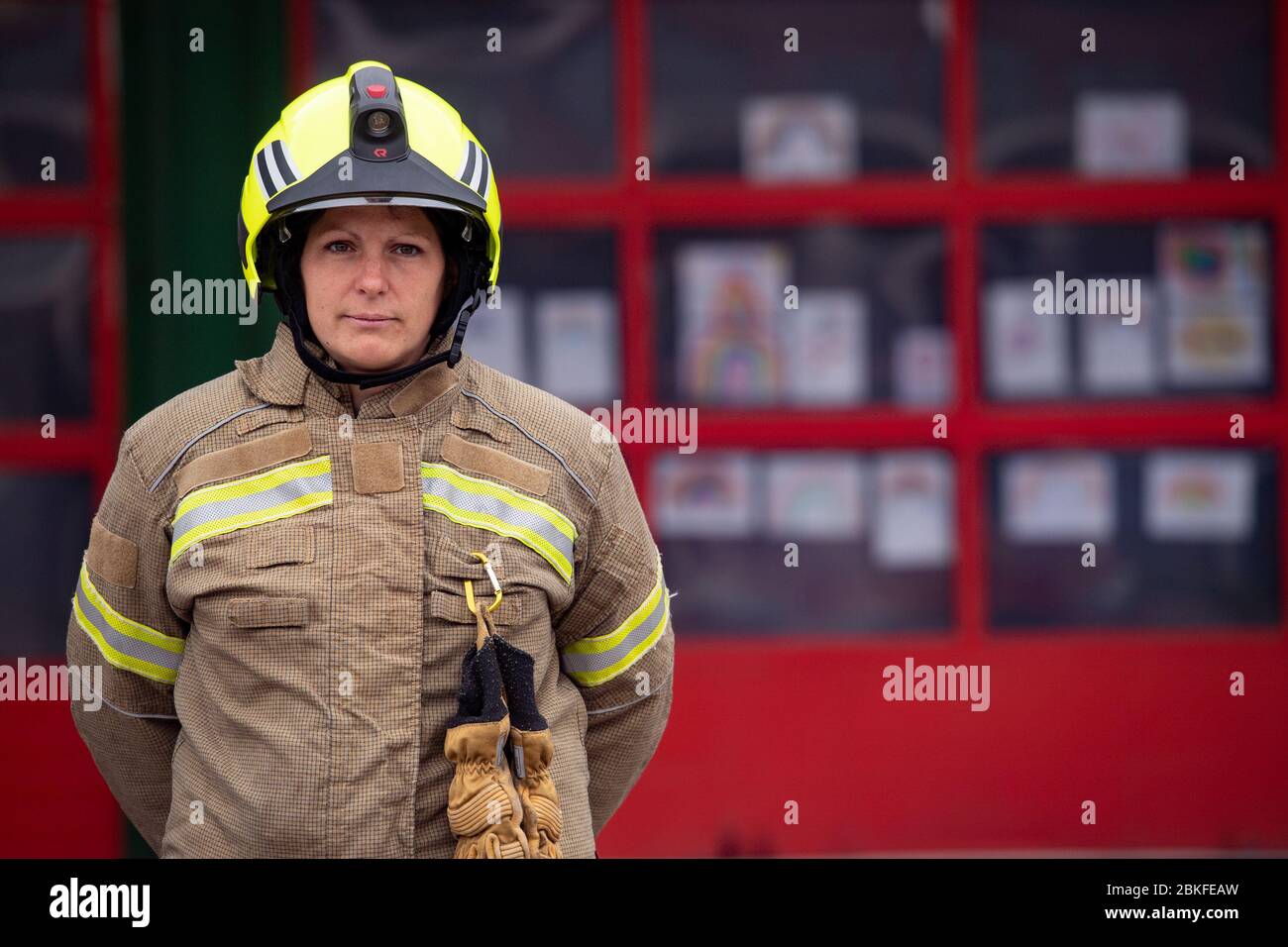 Firefighters observe a minute's silence outside Bournbrook Community fire station in Birmingham, in memory of their colleagues that lost their lives in the line of duty. Stock Photo