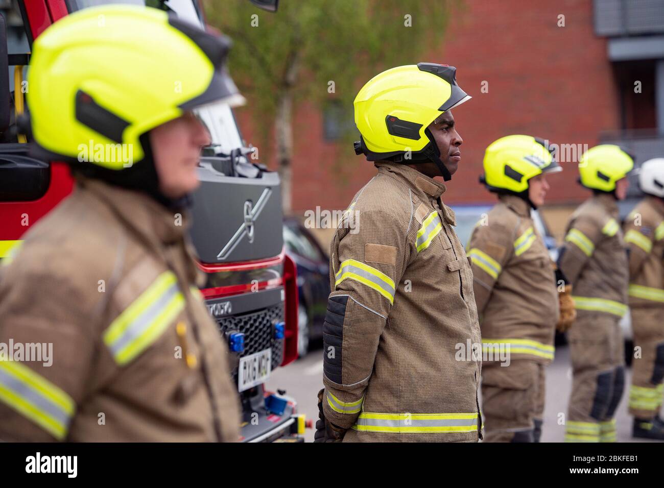 Firefighters observe a minute's silence outside Bournbrook Community fire station in Birmingham, in memory of their colleagues that lost their lives in the line of duty. Stock Photo