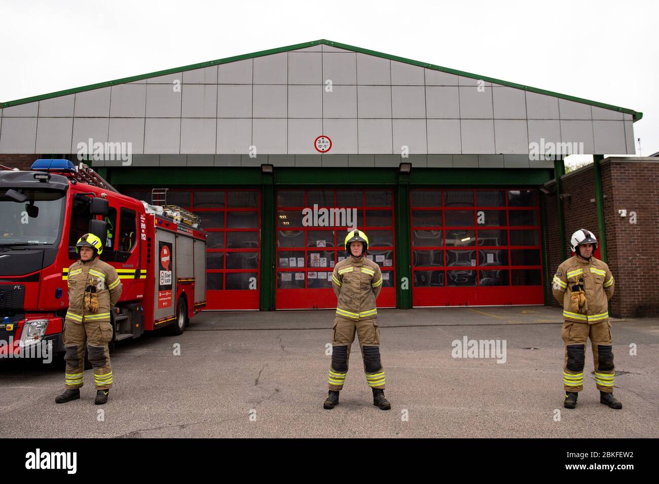 Firefighters observe a minute's silence outside Bournbrook Community fire station in Birmingham, in memory of their colleagues that lost their lives in the line of duty. Stock Photo