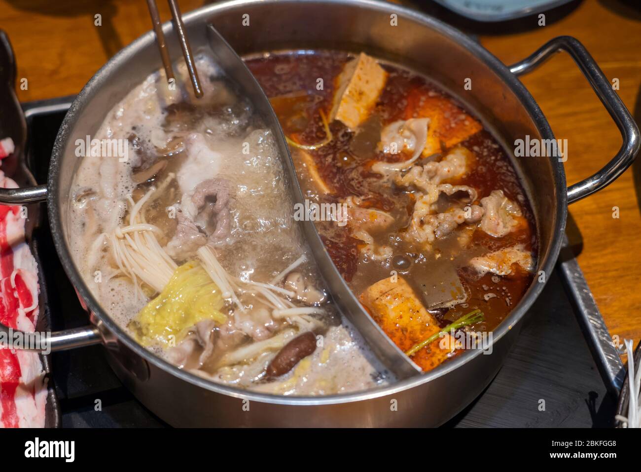 Customized combo pot with boiling hot soups, one spicy flavor and one