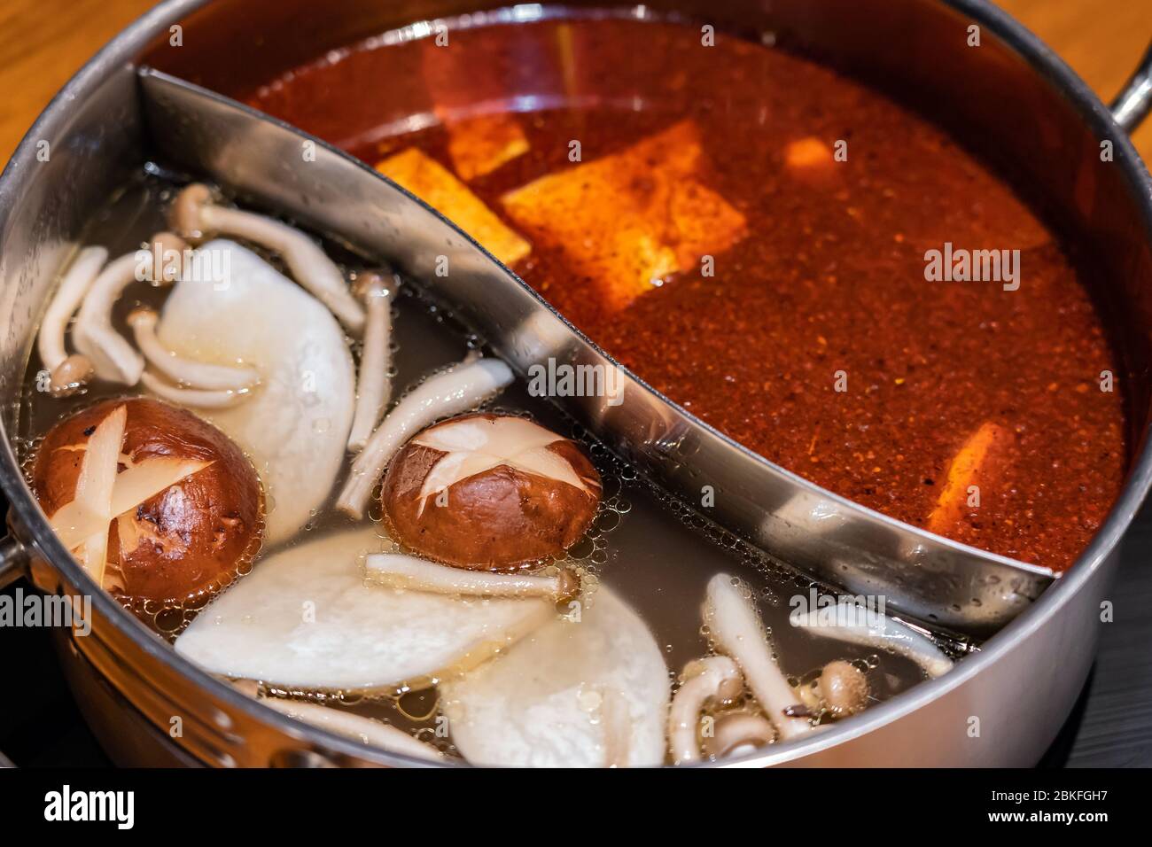 Specially made pot for soup base combo option to have two flavors spicy and mushroom of hot