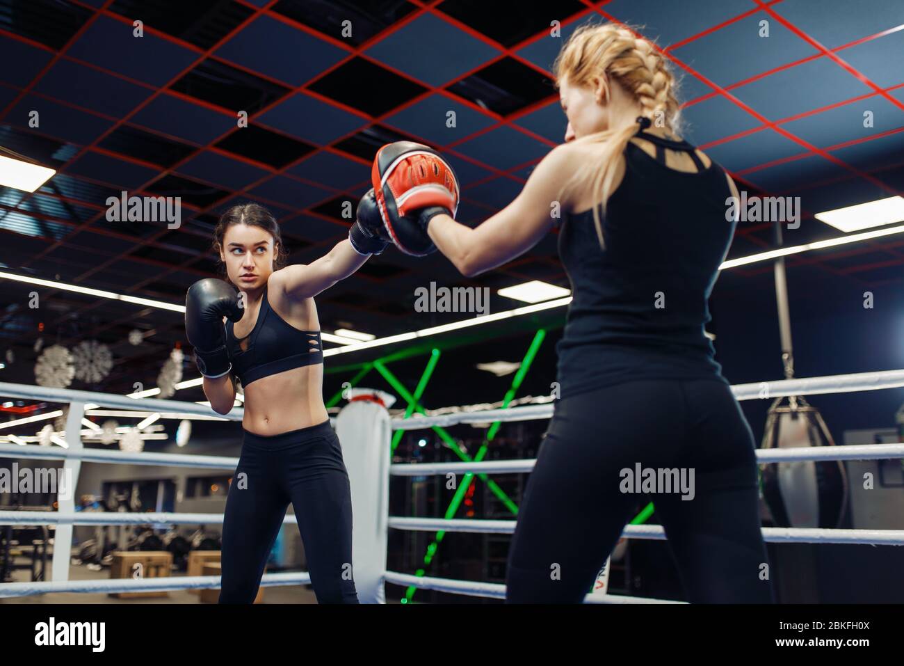 Two women boxing in the ring, box training Stock Photo