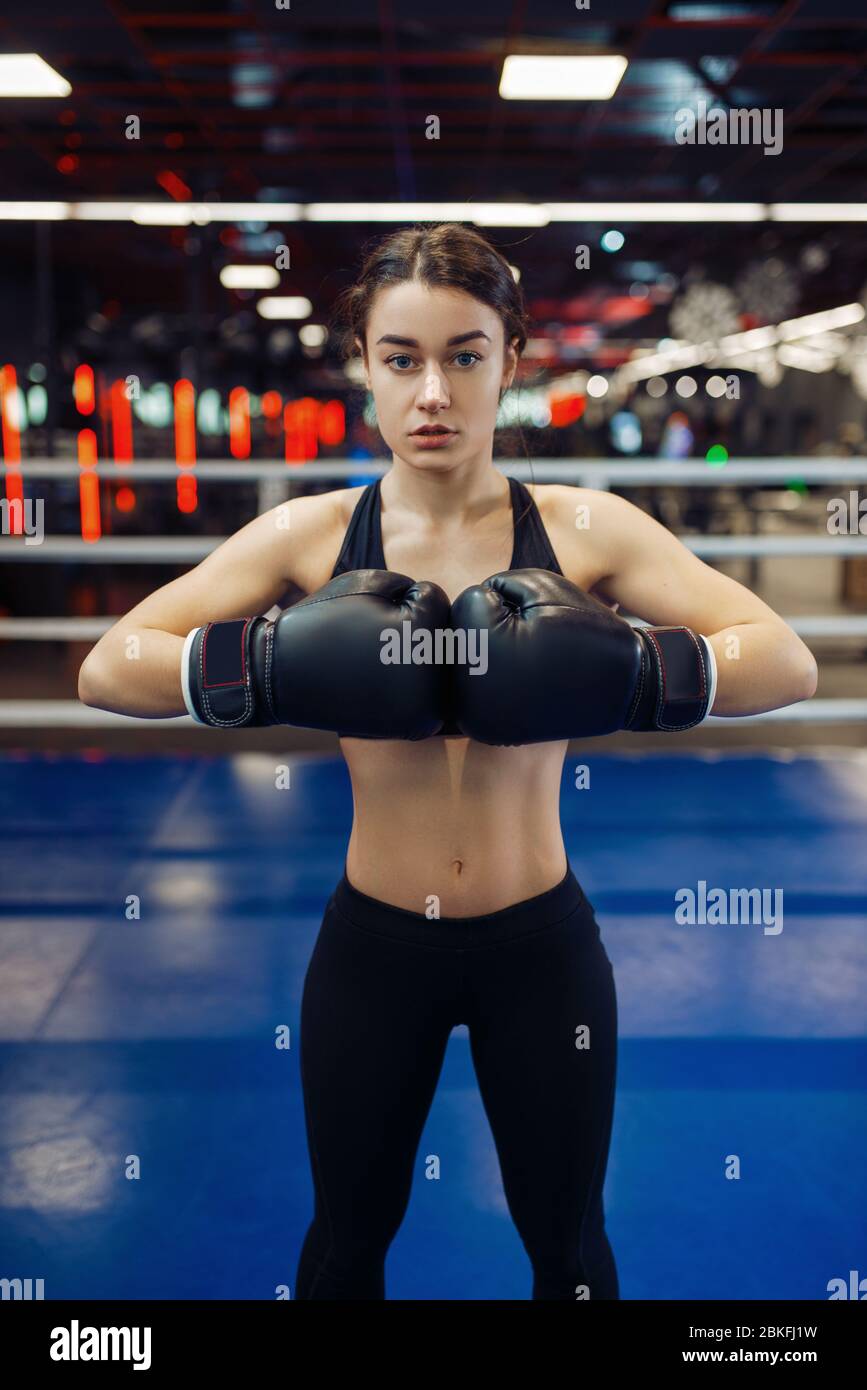 Woman in black boxing gloves, front view Stock Photo