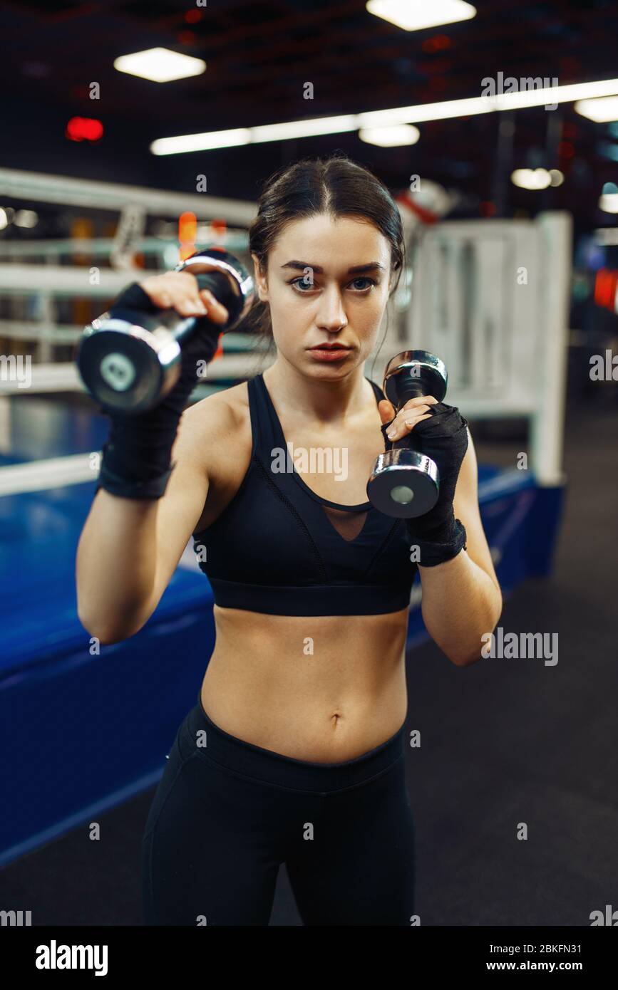 Woman doing exercise with dumbbells, box training Stock Photo