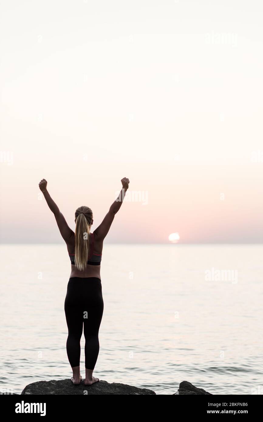 Woman standing sea raised arms hi-res stock photography and images - Alamy