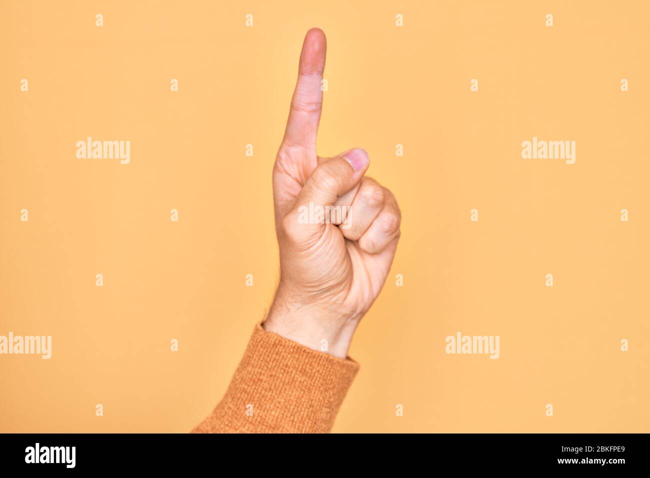 Hand of caucasian young man showing fingers over isolated yellow ...