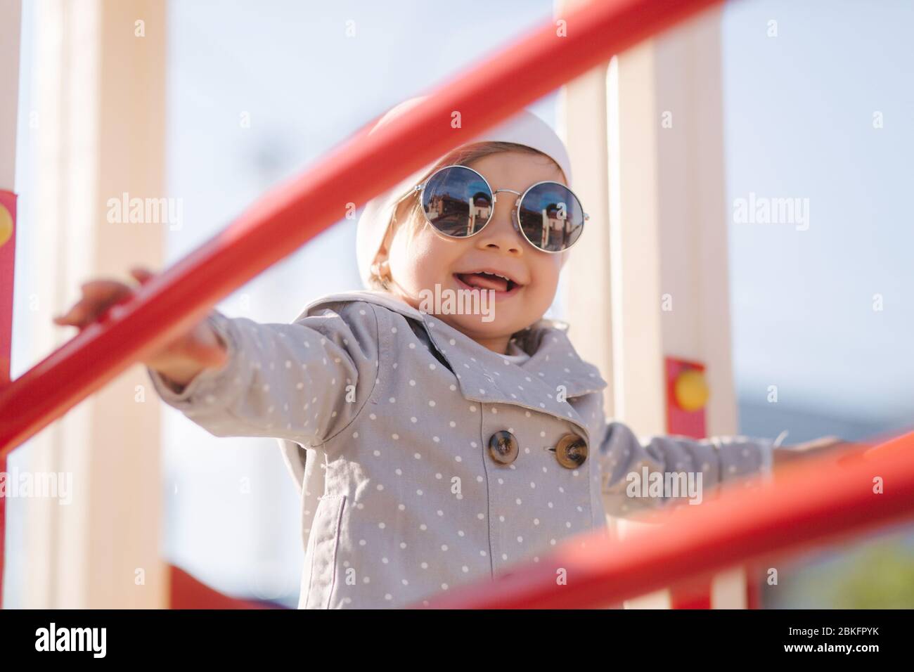 Cute little girl walk in playground and have fun. Adorable girl in stylish clothes Stock Photo