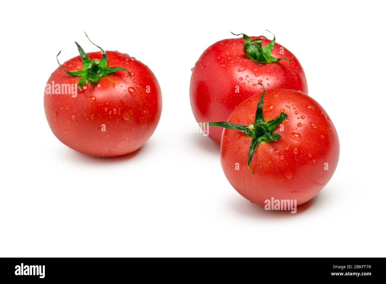 Three ripe tomatoes isolated on white background Stock Photo - Alamy