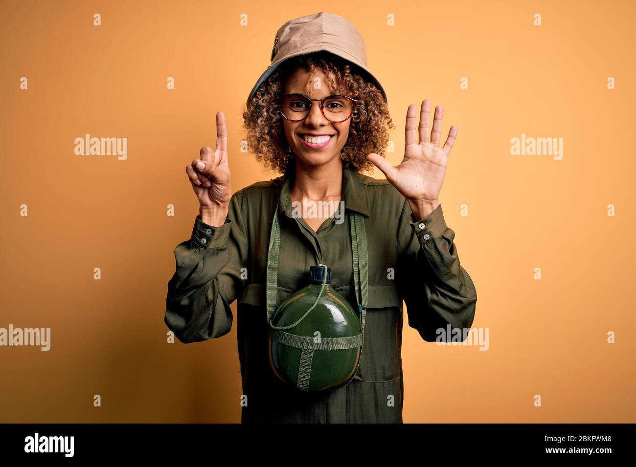 Young african american tourist woman on vacation wearing explorer hat ...