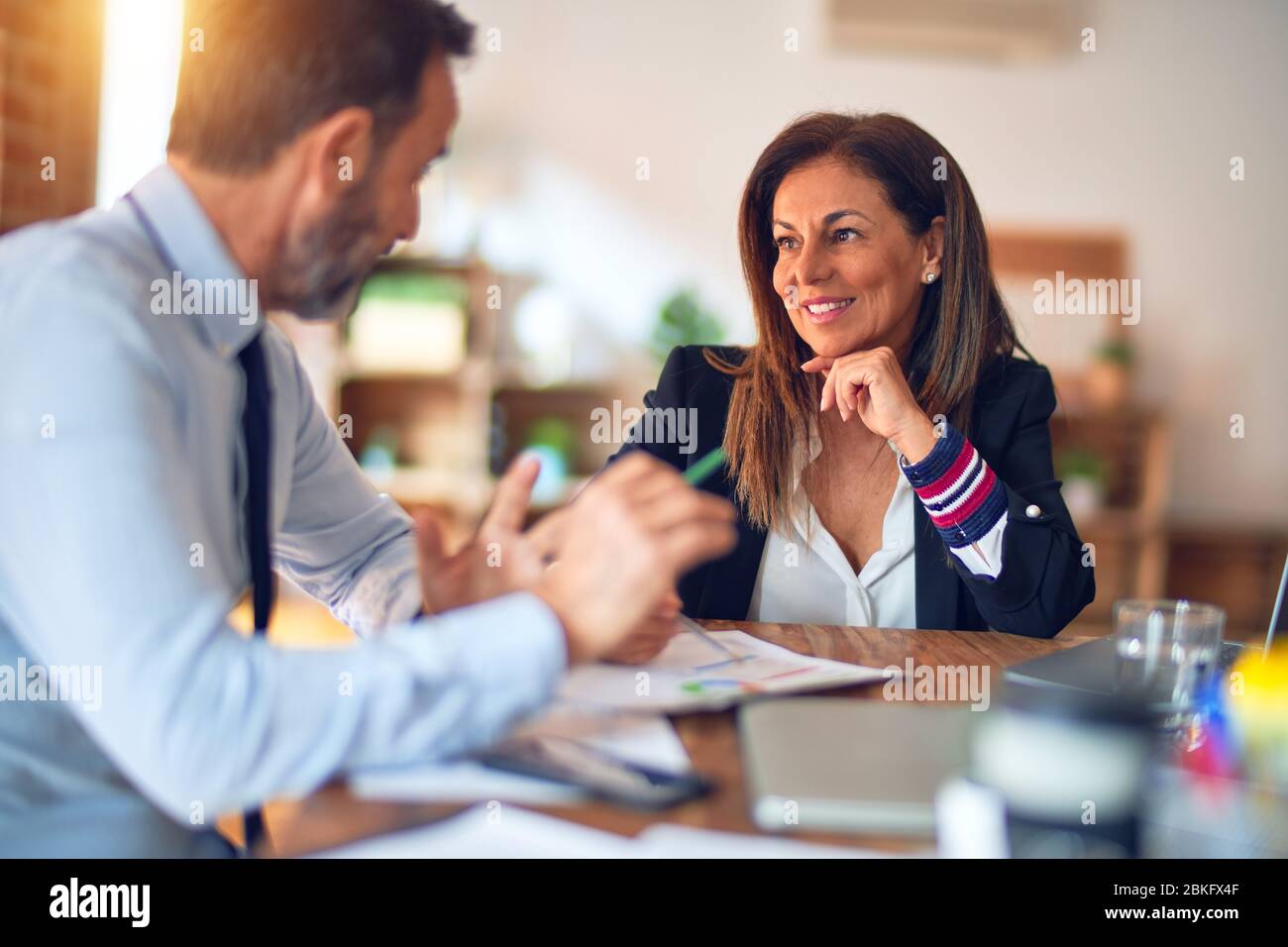 Two middle age business workers smiling happy and confident. Working ...
