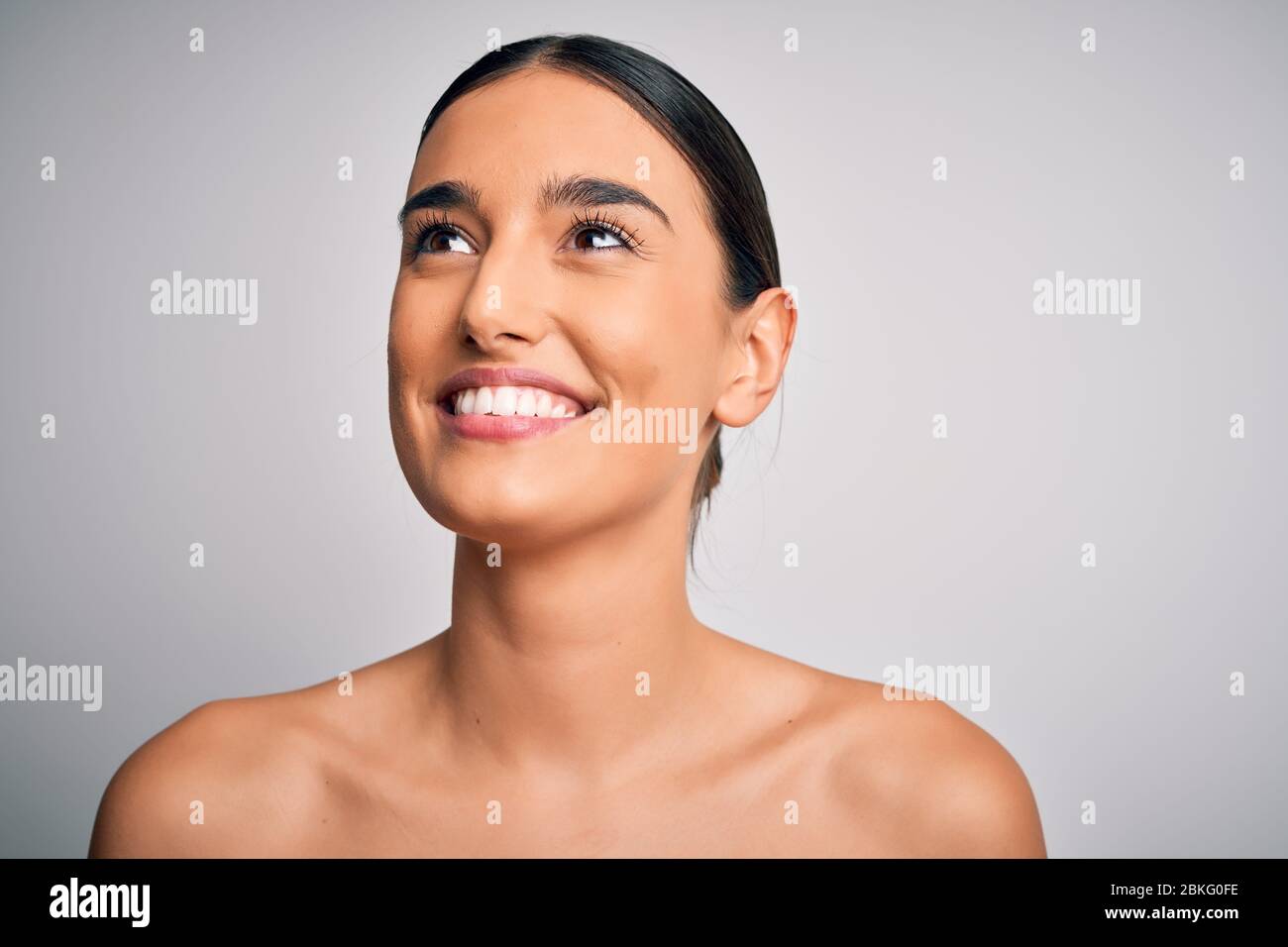 Close up of young beautiful woman with clear and pure skin. Perfect and ...