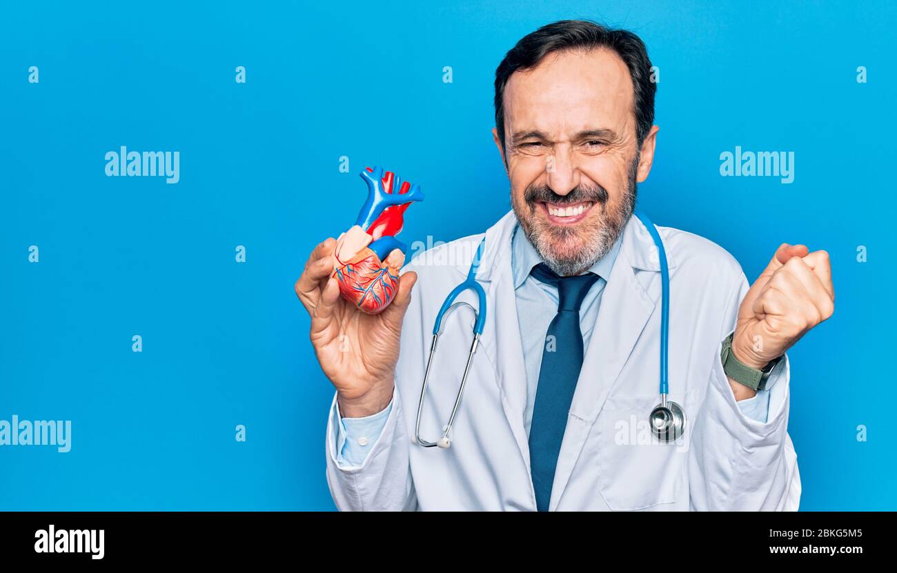 Middle age handsome cardiologist man wearing coat and stethoscope ...