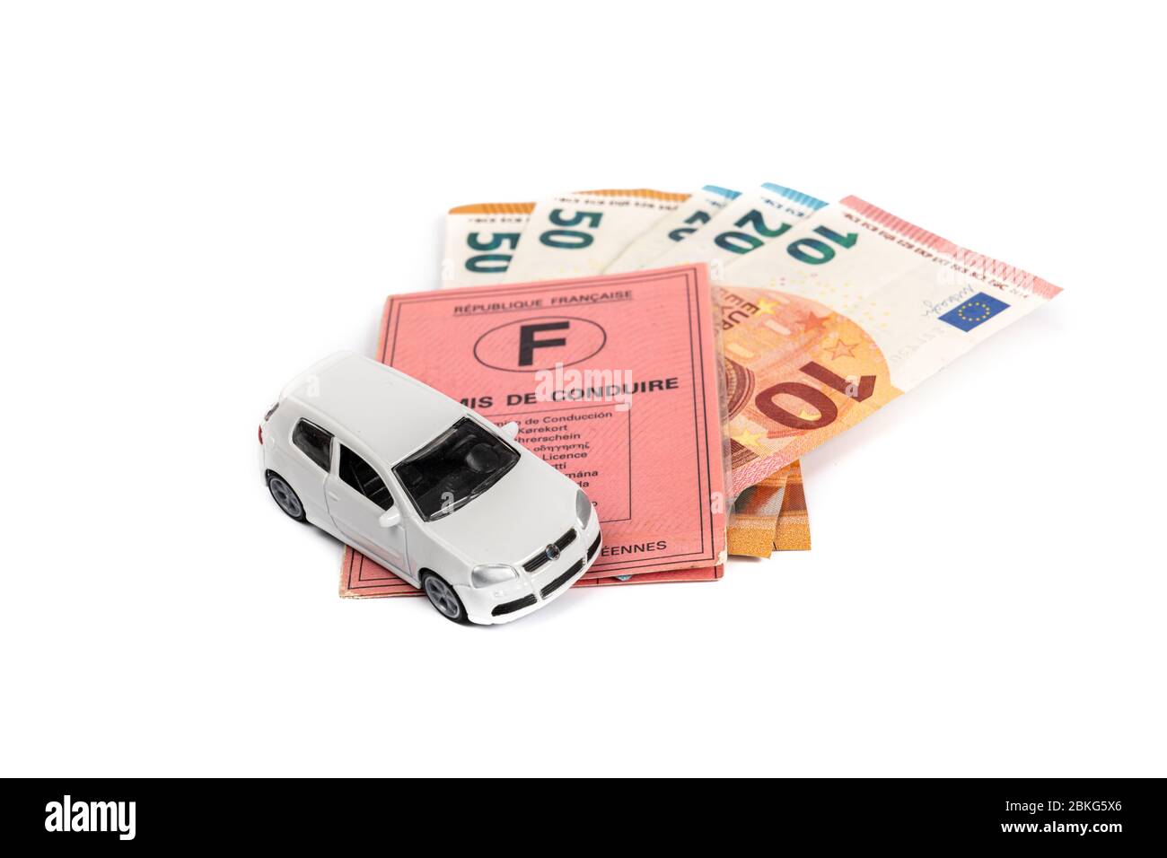 French driving license valid in all European countries on white background and money. Concept : Driving license is expensive in France. Stock Photo