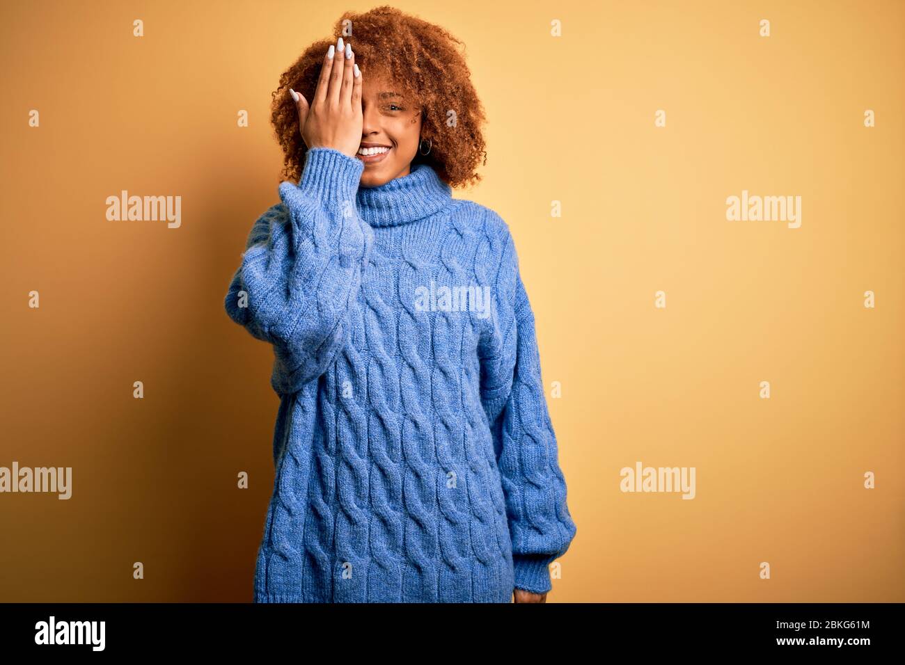 Young beautiful African American afro woman with curly hair wearing ...
