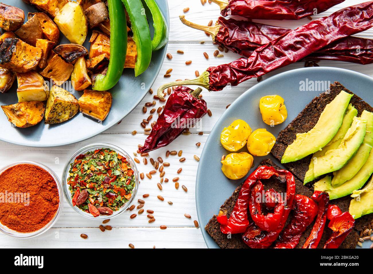 Traditional mexican food. Spicy roasted sweet potatoes (batata) and grilled  paprika and avocado healthy toasts on white table background, top view  Stock Photo - Alamy