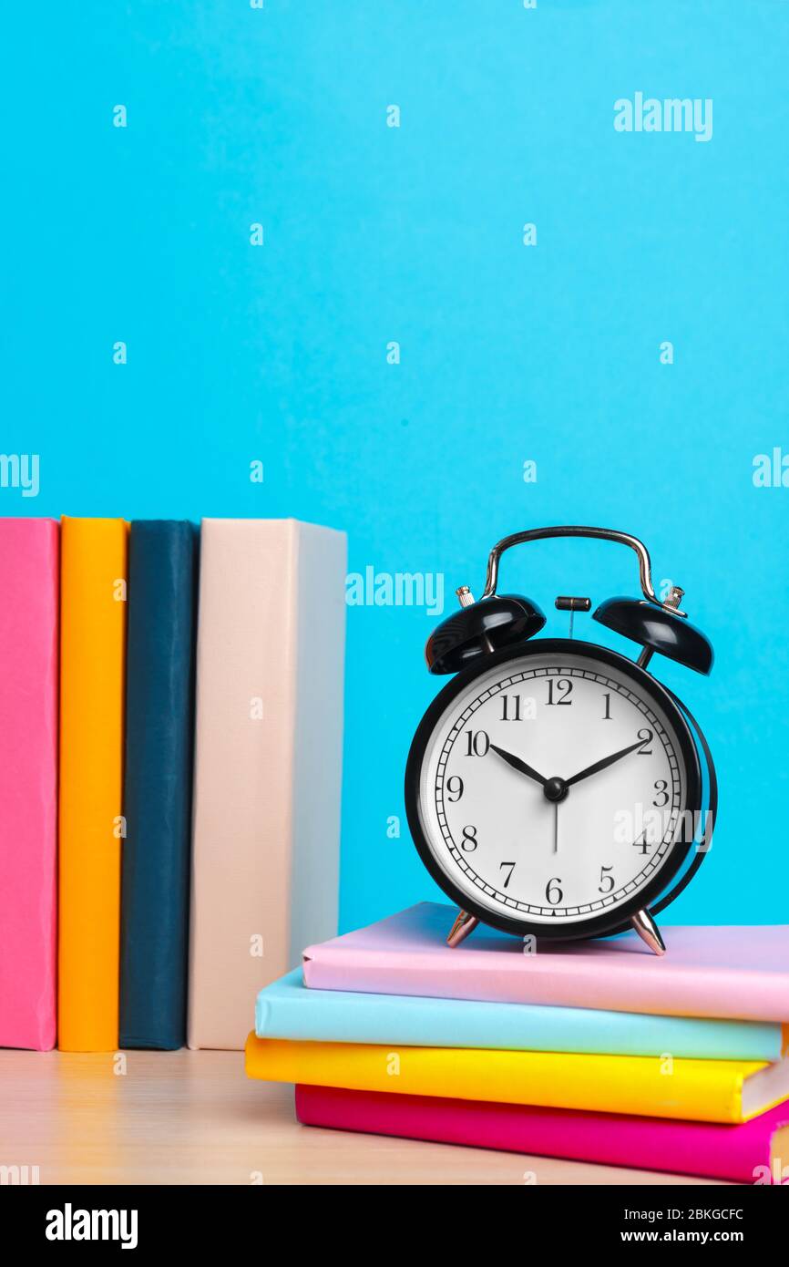 Back to school background with books and alarm clock Stock Photo - Alamy