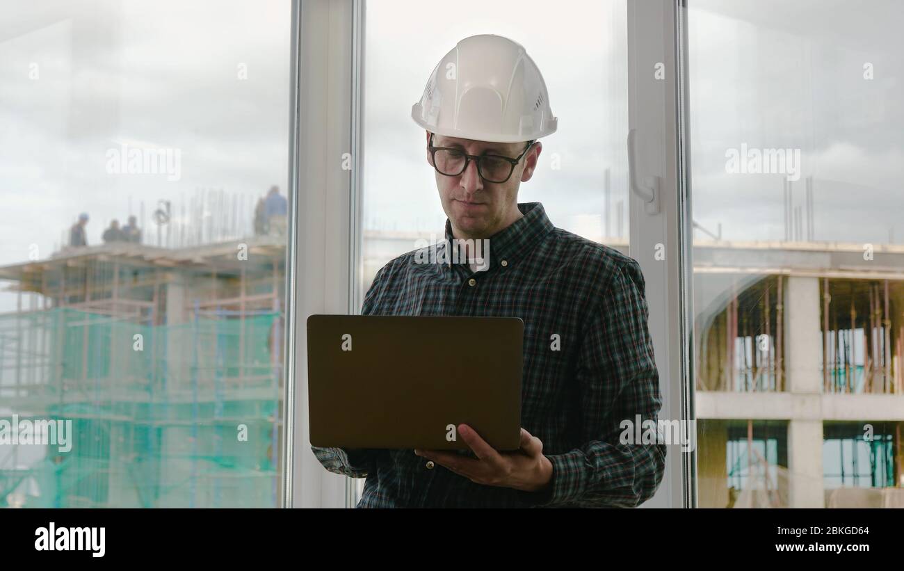 Handsome male engineer is using a notebook for work. Stock Photo