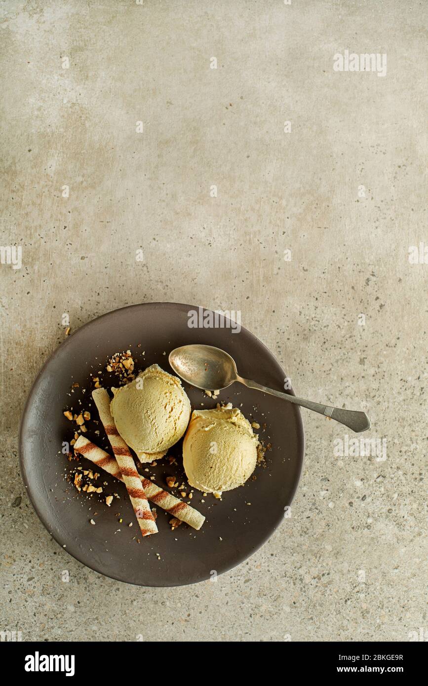Homemade Organic Vanilla soft Ice Cream scoops with two wafer straws Stock Photo