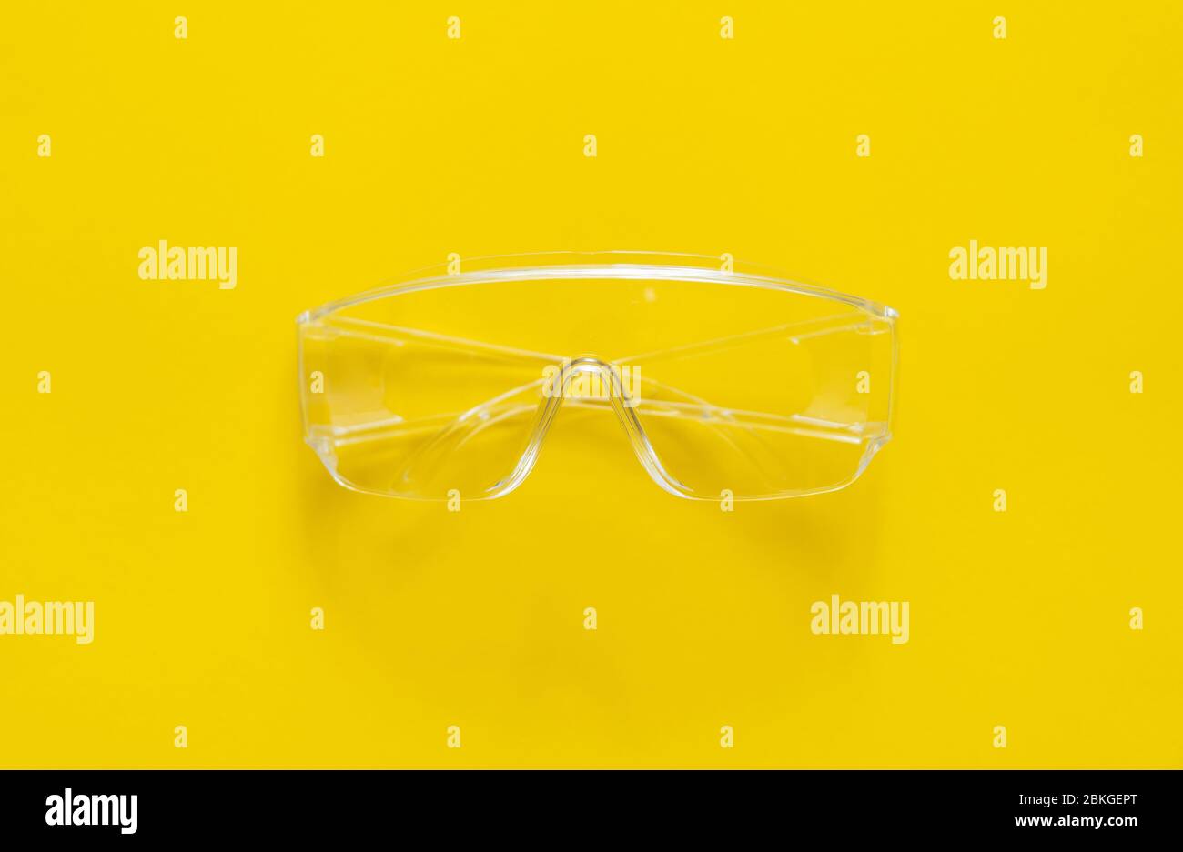 Protective glasses lying on a yellow background. Stock Photo