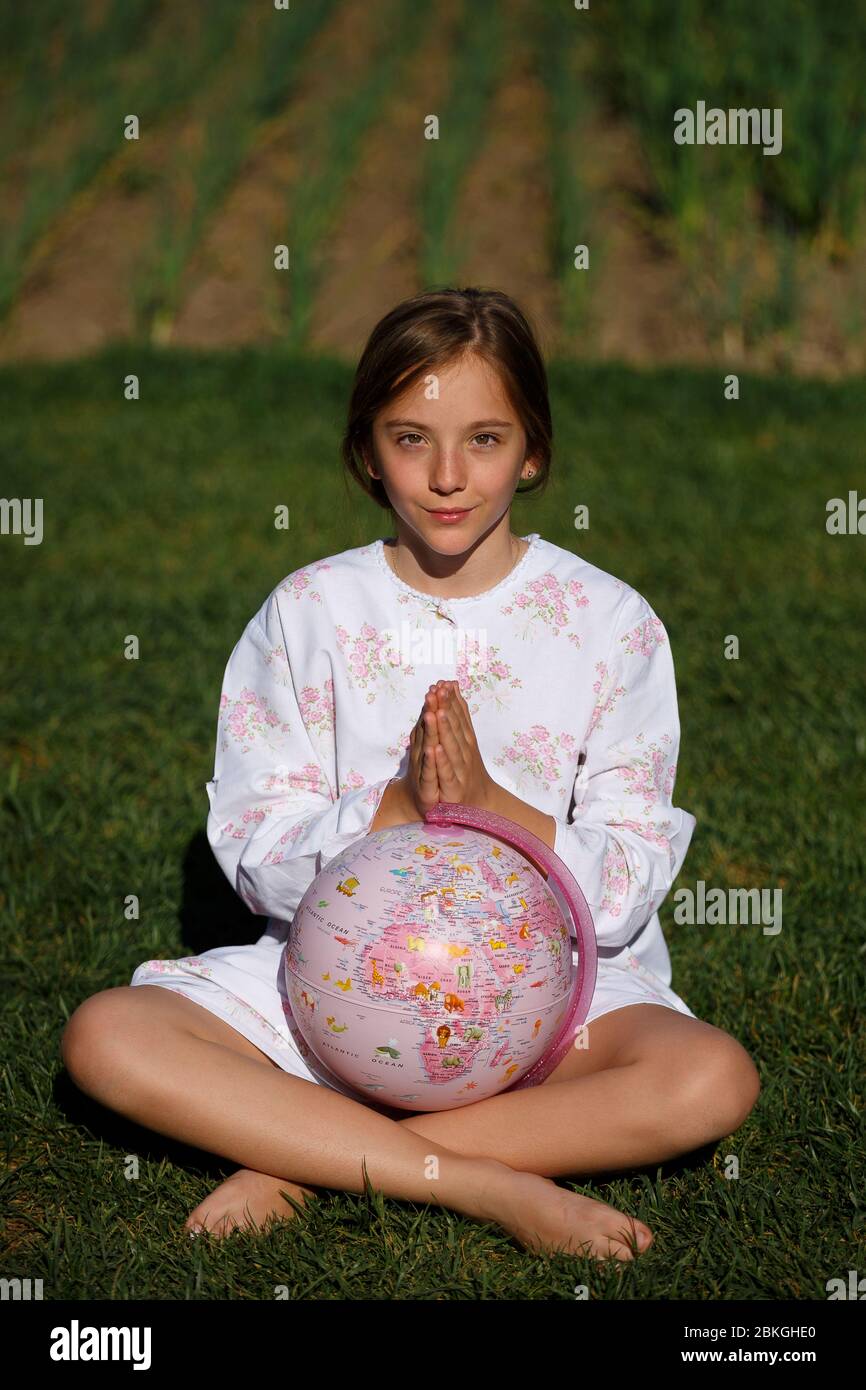 Young girl keeping an earth globe send a message about Save Earth Stop Pollution Climate Strike Disease Outbreak Coronavirus Covid-19 Concept Spreadin Stock Photo