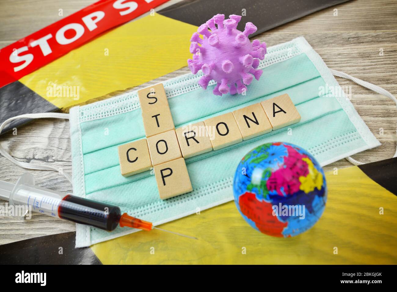 Game letters forming the words Corona and stop on a protective mask Symbolic photo for measures against the coronavirus pandemic  /  Spielbuchstaben b Stock Photo