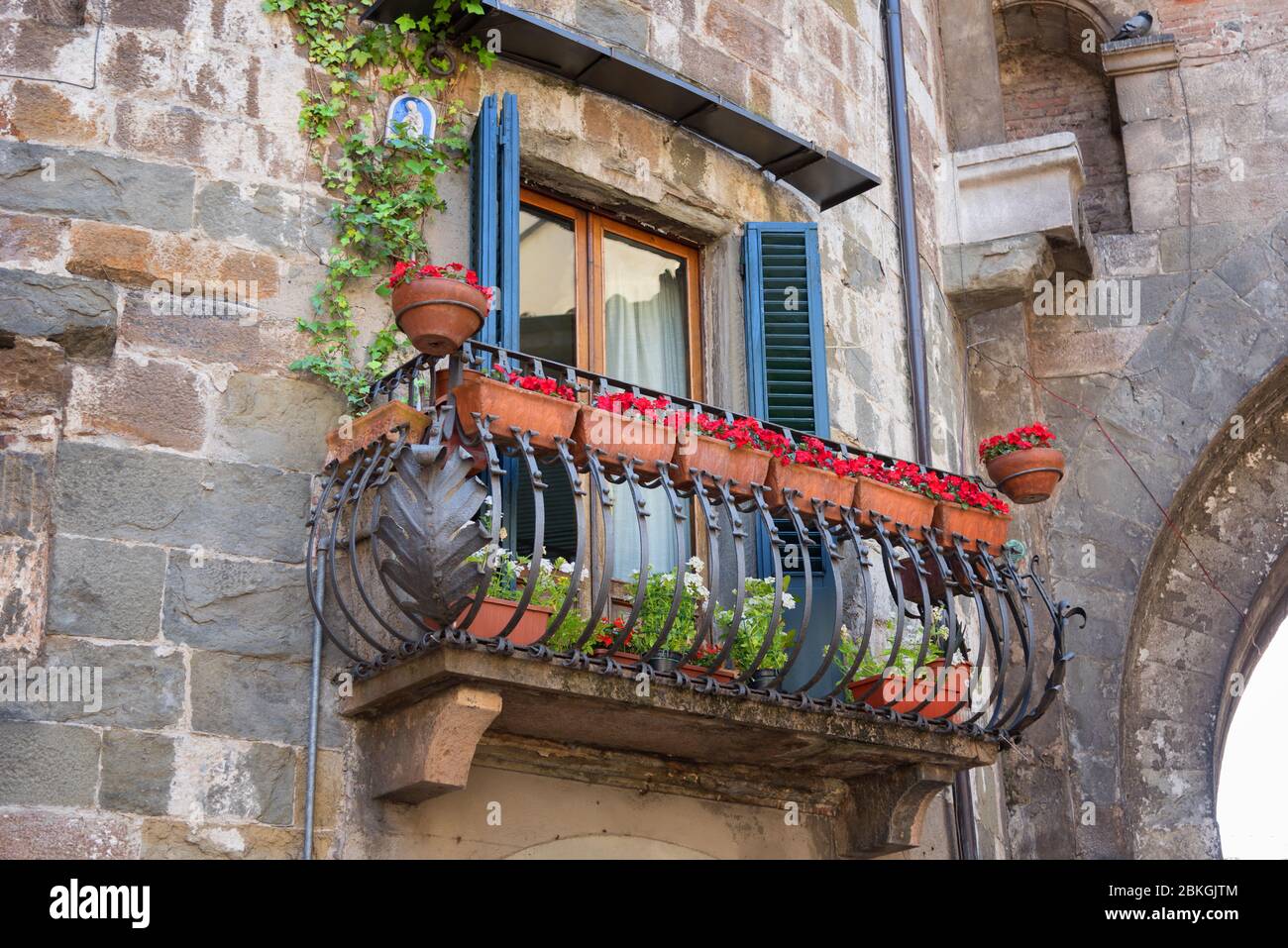 Picturesque flower decorated balcony in Medieval Town Lucca in Italy. Stock Photo