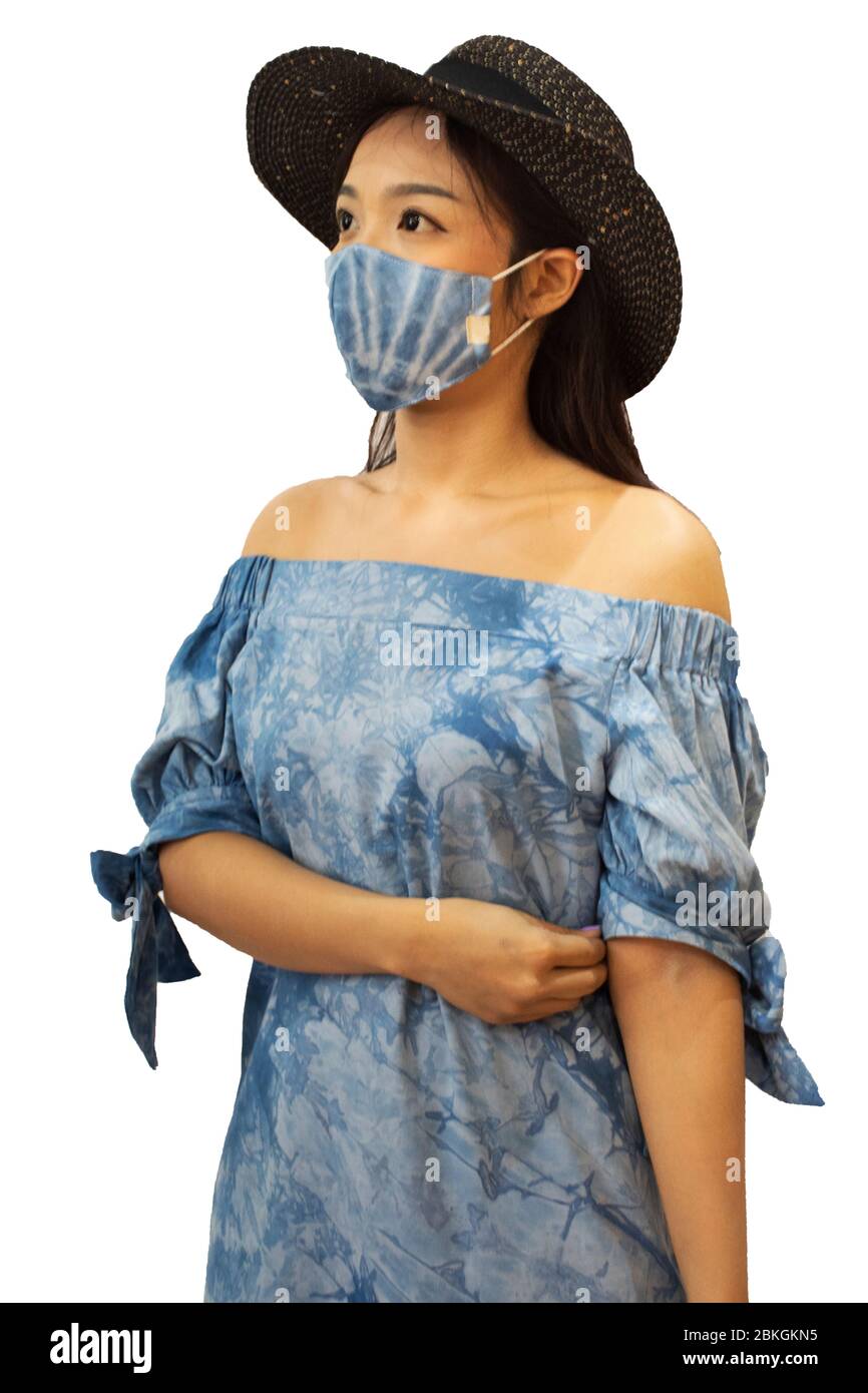 Thai women wear handmade indigo fabric mask with hat and posing portrait for take photo at studio while Coronavirus COVID 19 outbreak and PM 2.5 Dust Stock Photo