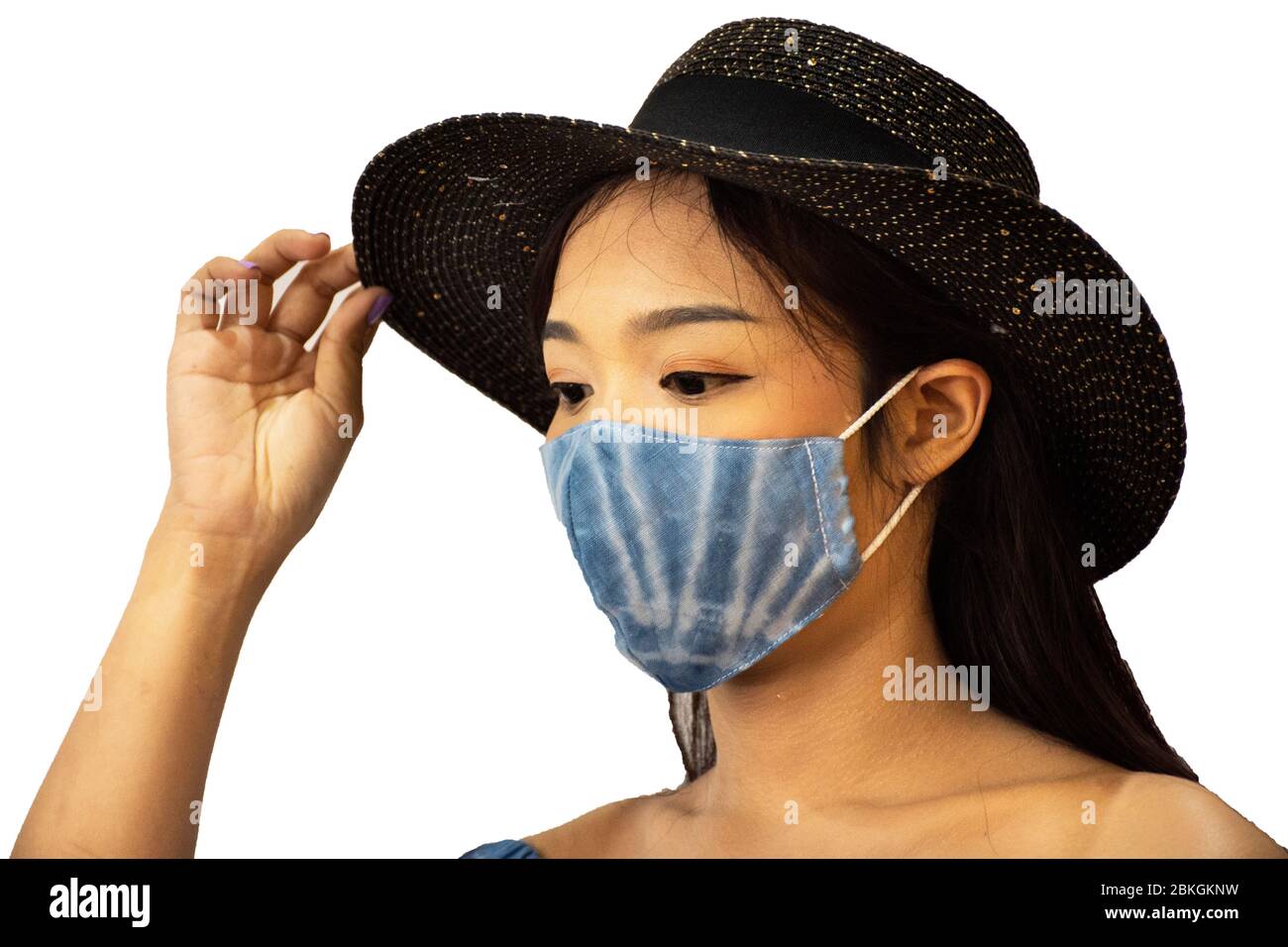Thai women wear handmade indigo fabric mask with hat and posing portrait for take photo at studio while Coronavirus COVID 19 outbreak and PM 2.5 Dust Stock Photo