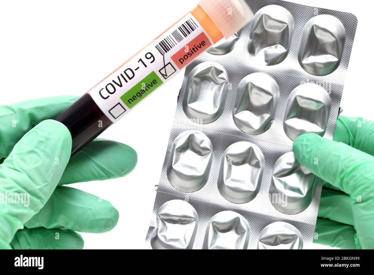PHOTOMONTAGE, hands in latex gloves holding Covid-19 blood collection tubes and empty tablet blister, Symbolfoto Corona crisis and shortages of drugs Stock Photo