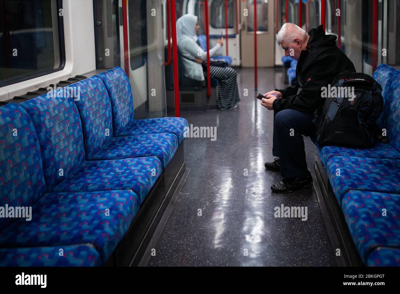 Members of the public stay socially distant on the Central Line as the UK continues in lockdown to help curb the spread of the coronavirus. Stock Photo