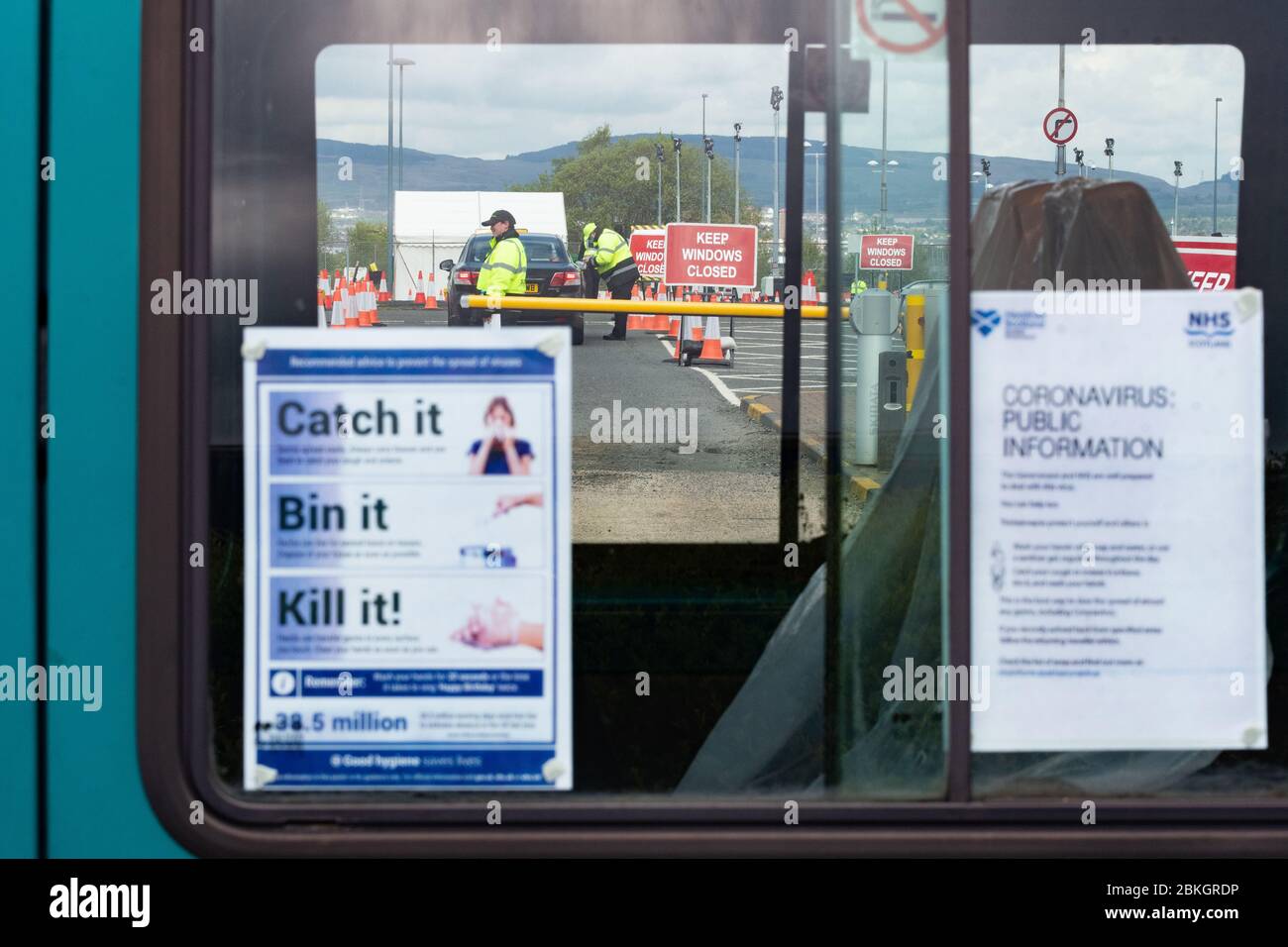 Glasgow, Scotland, UK. 4th May, 2020. Coronavirus testing at Glasgow Airport in the long stay carpark continues at a steady pace with no evidence of queuing at lunchtime today. Testing site seen through the windows of a bus being used by the NHS temporarily parked at the entrance Credit: Kay Roxby/Alamy Live News Stock Photo
