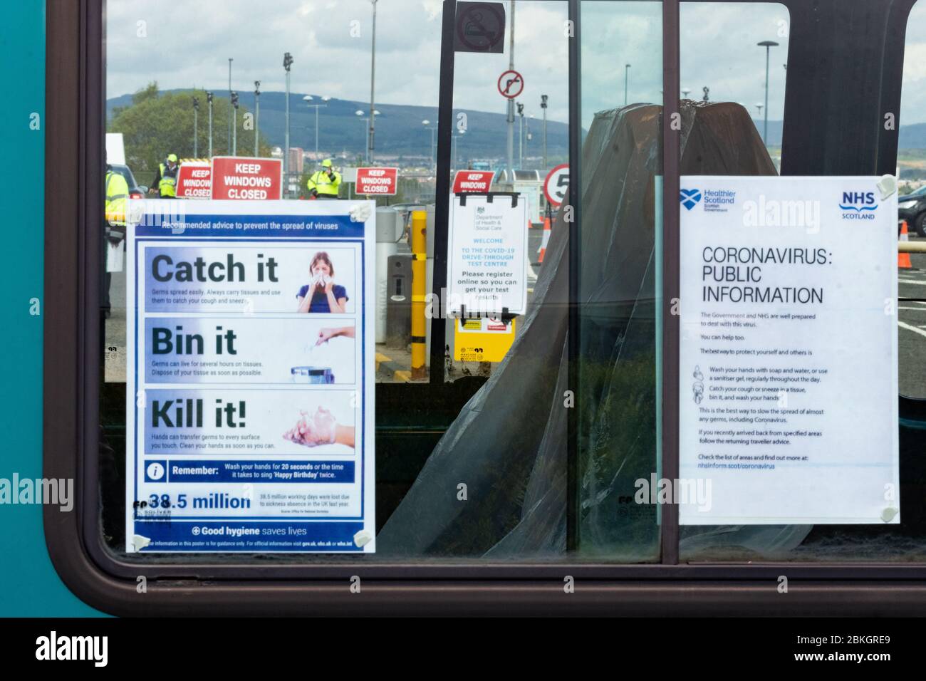 Glasgow, Scotland, UK. 4th May, 2020. Coronavirus testing at Glasgow Airport in the long stay carpark continues at a steady pace with no evidence of queuing at lunchtime today. Testing site seen through the windows of a bus being used by the NHS temporarily parked at the entrance Credit: Kay Roxby/Alamy Live News Stock Photo
