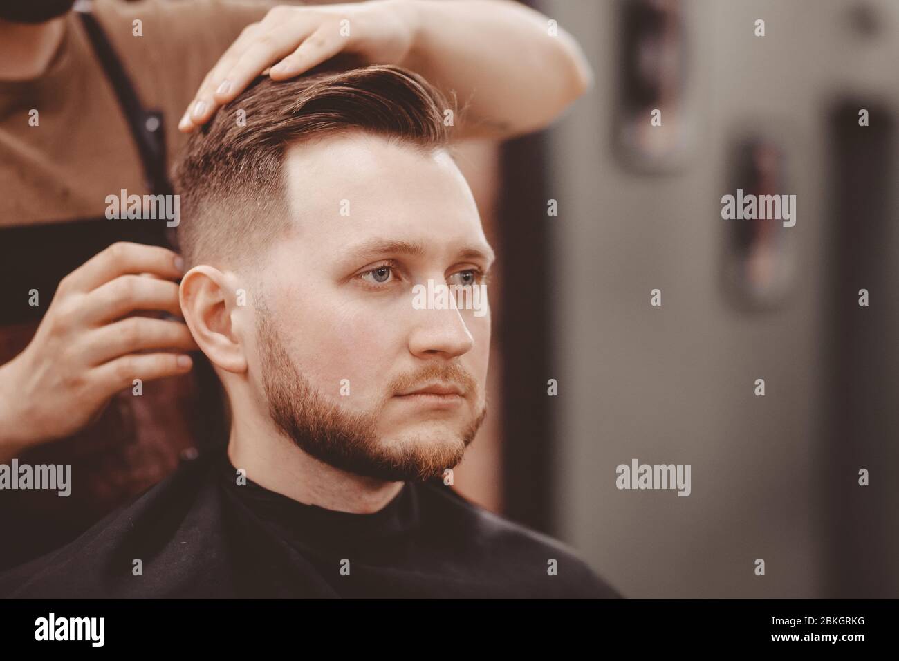 Barbershop banner. Man in barber chair, hairdresser styling his hair Stock  Photo - Alamy