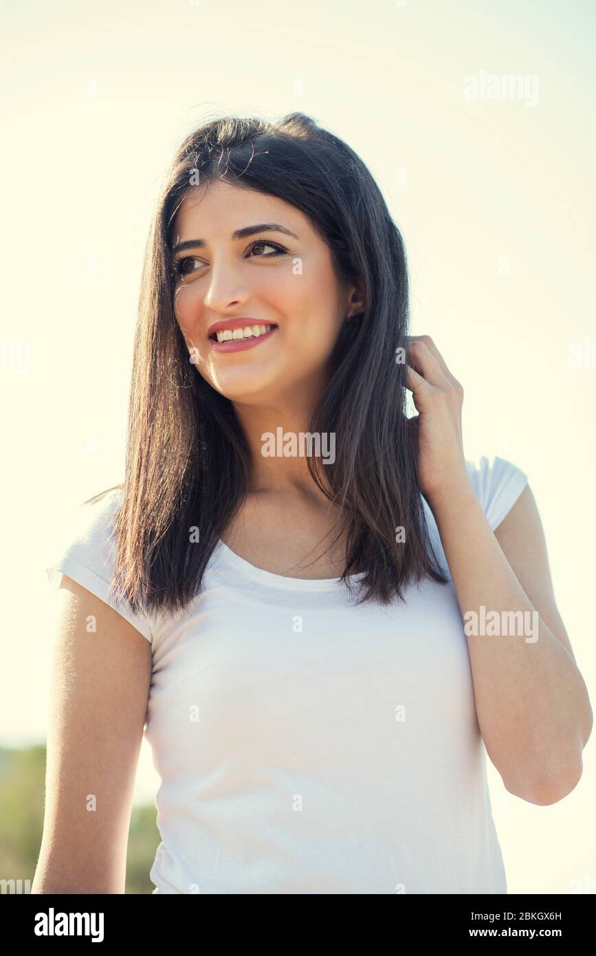 Beautiful young woman smiling outdoors Stock Photo