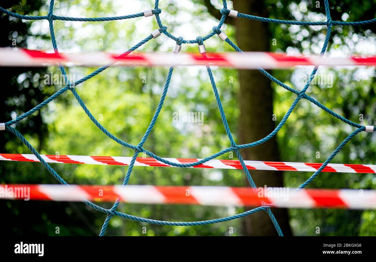 Oldenburg, Germany. 04th May, 2020. A climbing frame in the schoolyard of the old grammar school is cordoned off with flutter tape. In Lower Saxony, schools were closed since mid-March due to the Corona pandemic. Classes are to return to schools step by step, grammar schools will start their classes on 11 May. Credit: Hauke-Christian Dittrich/dpa/Alamy Live News Stock Photo