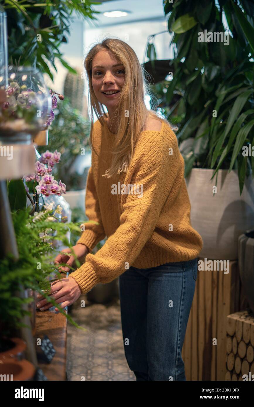 Young woman standing in flower shop Stock Photo