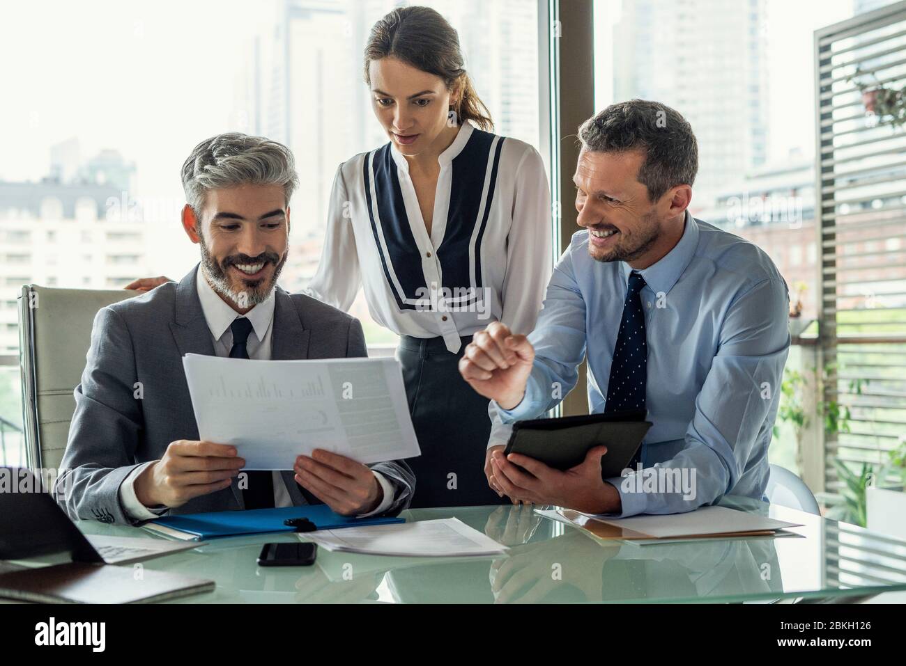 Smiling business people working in office Stock Photo