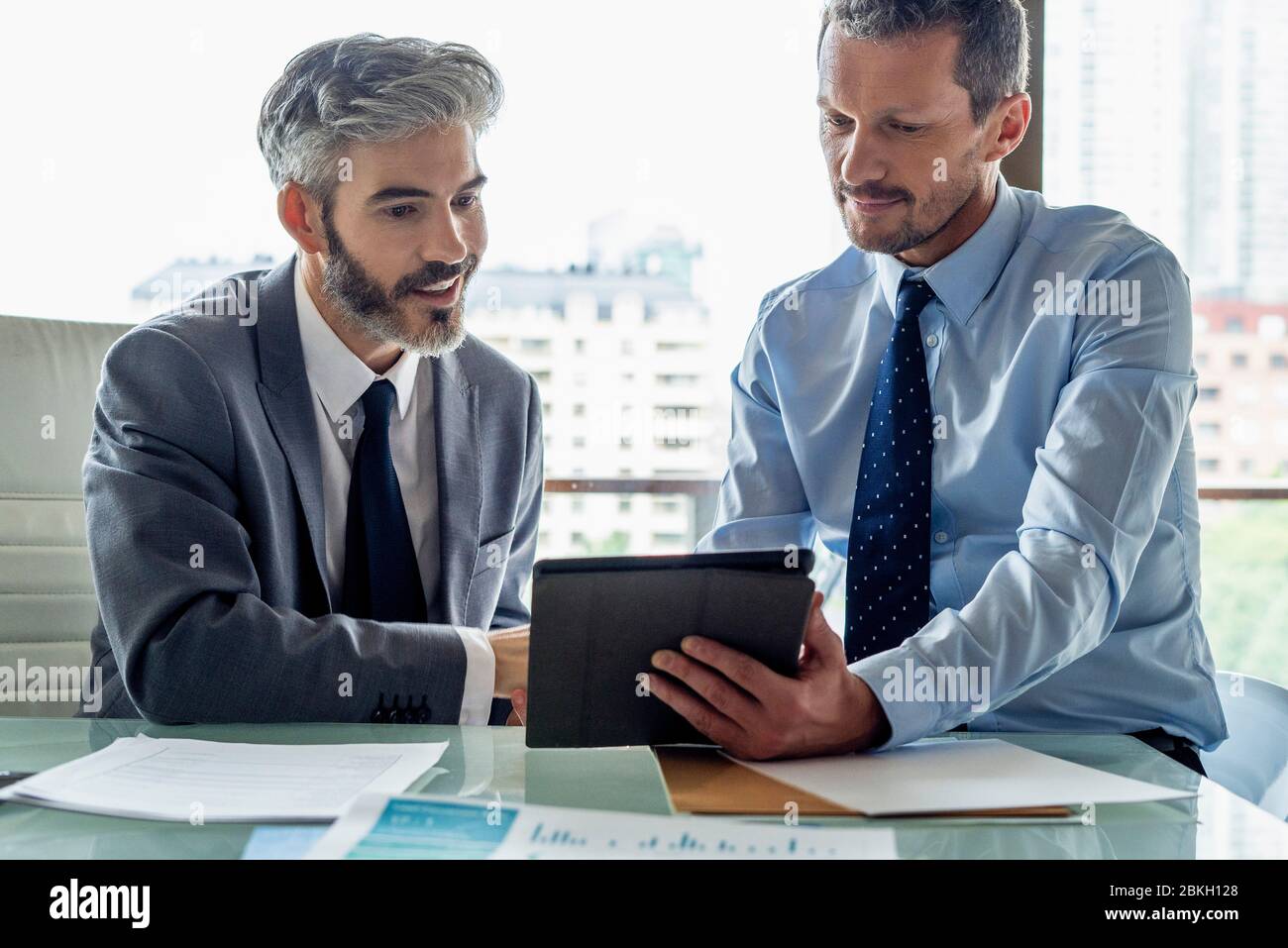 Businessmen looking at digital tablet Stock Photo
