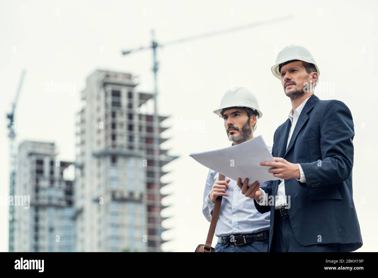 Male architects working at construction site Stock Photo