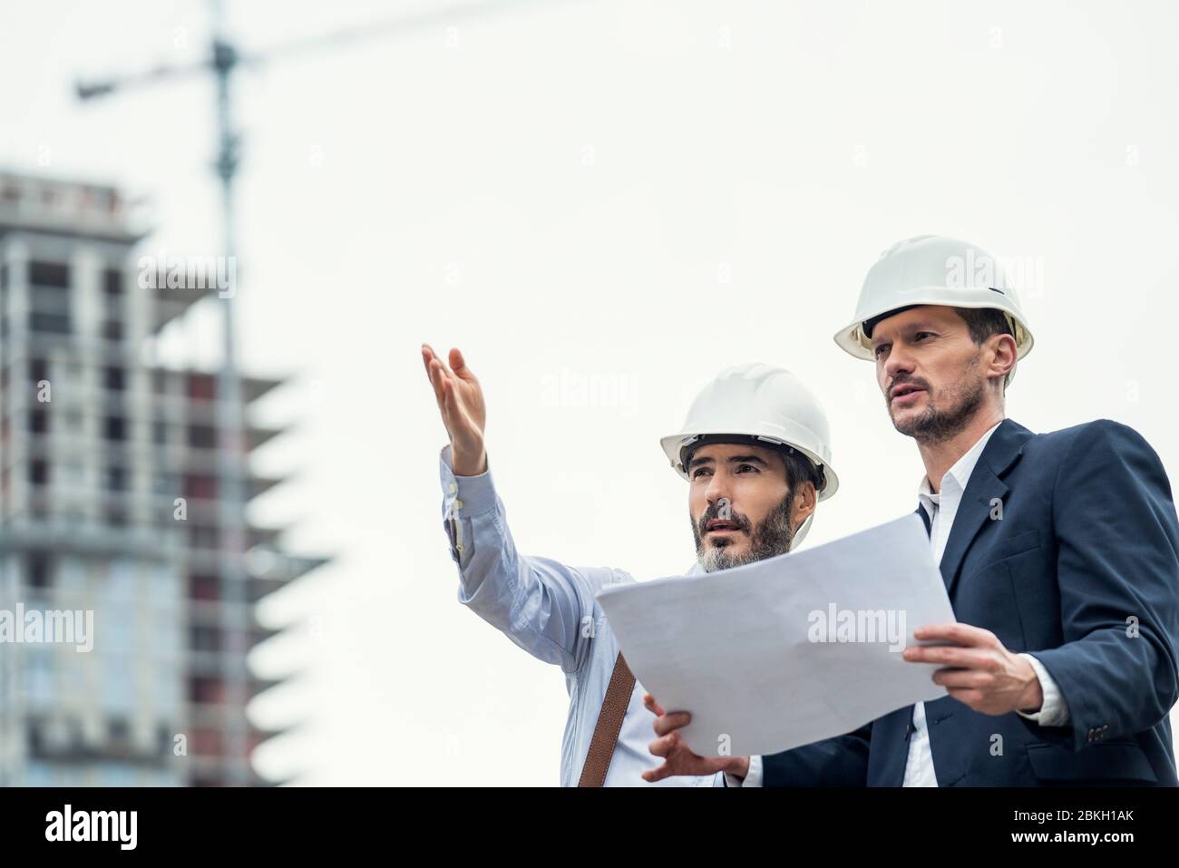 Male architects working at construction site Stock Photo