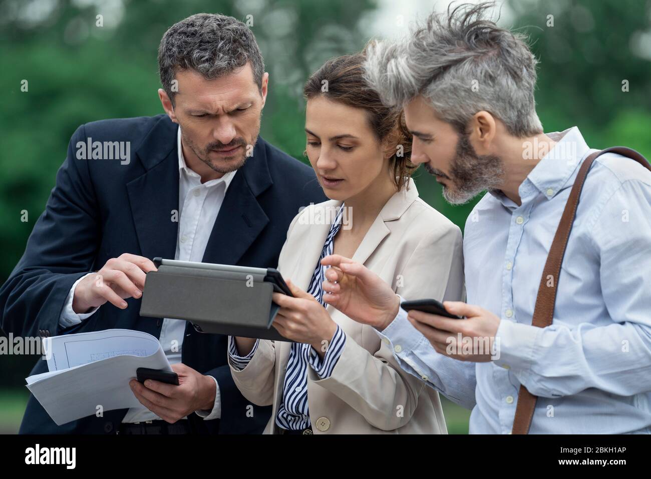 Architects using digital tablet outdoors Stock Photo
