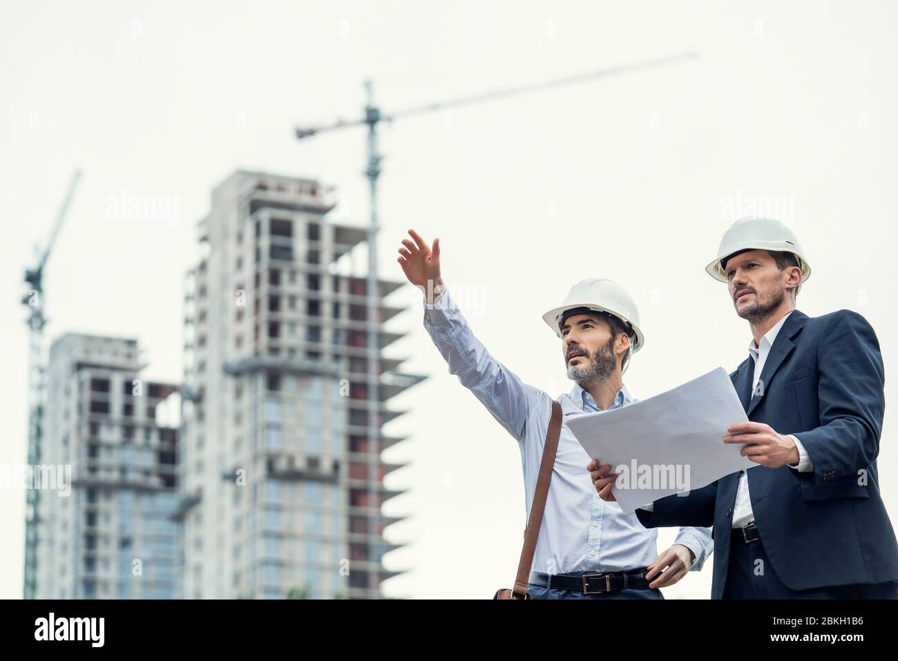 Male architects working at construction site Stock Photo