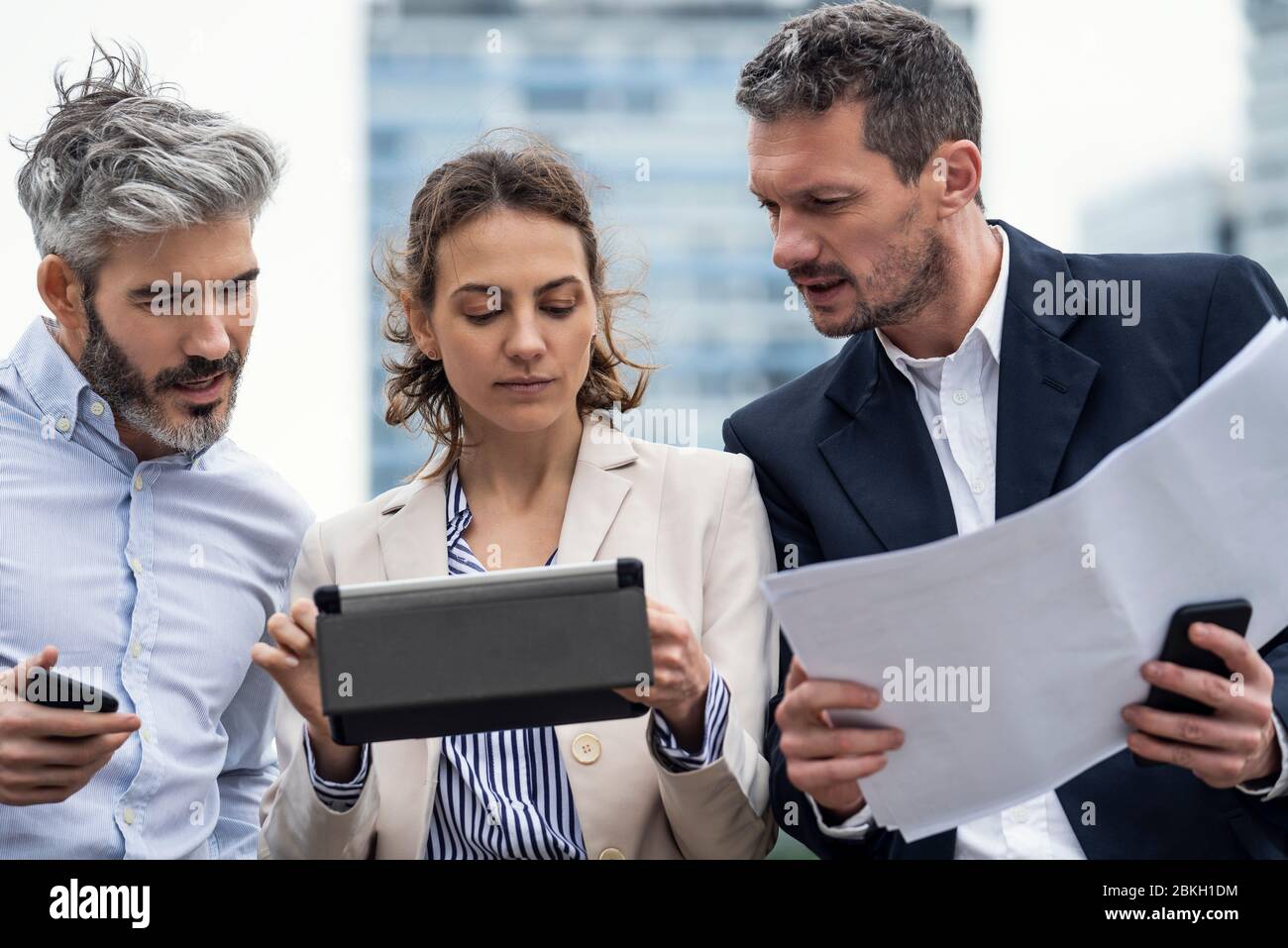 Architects using digital tablet outdoors Stock Photo