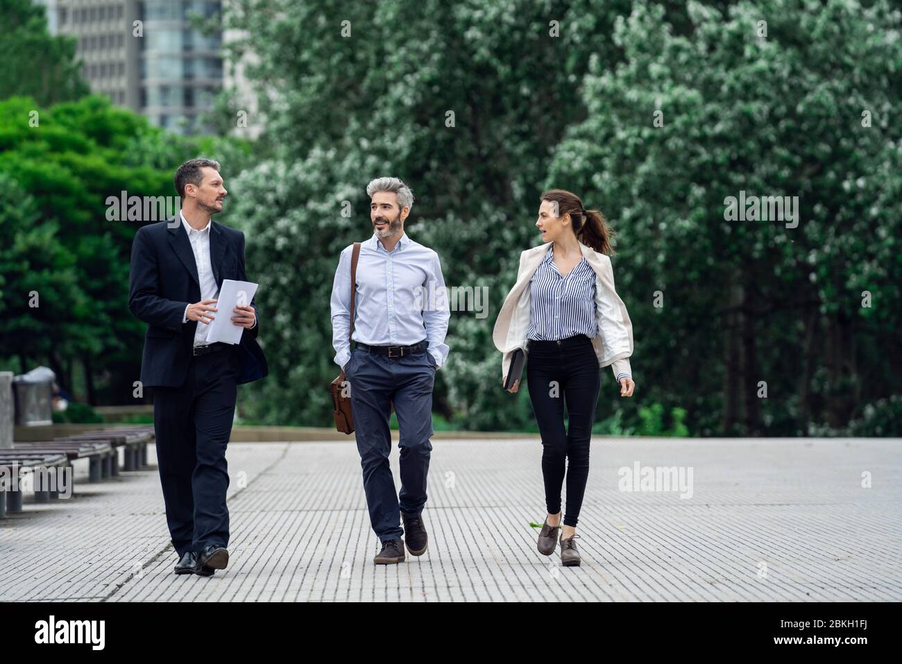 Architects talking with each other in public park Stock Photo