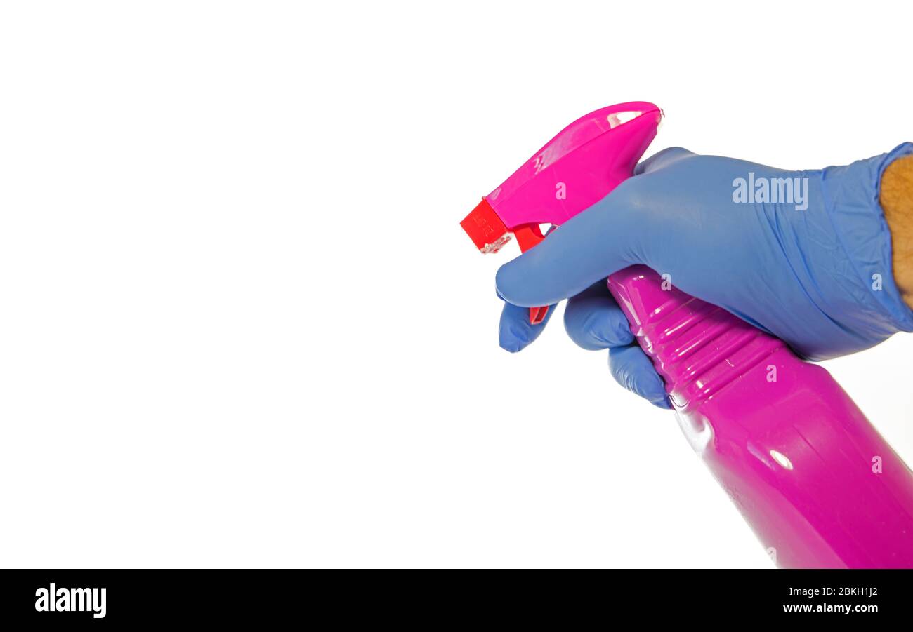 Cleaning supplies on white background and hand in glove holding a desinfection spray Stock Photo