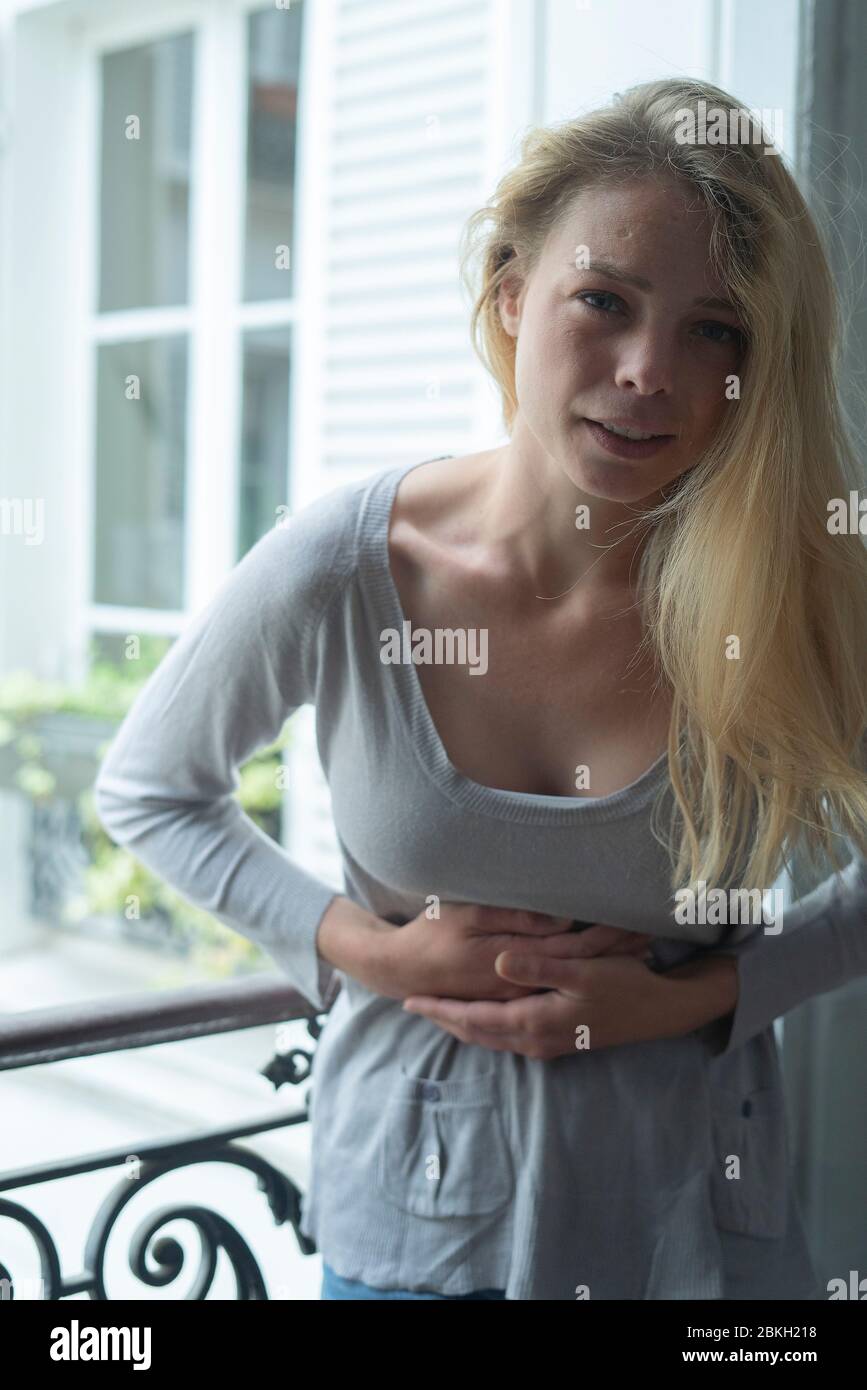 Young woman suffering from stomach cramps Stock Photo