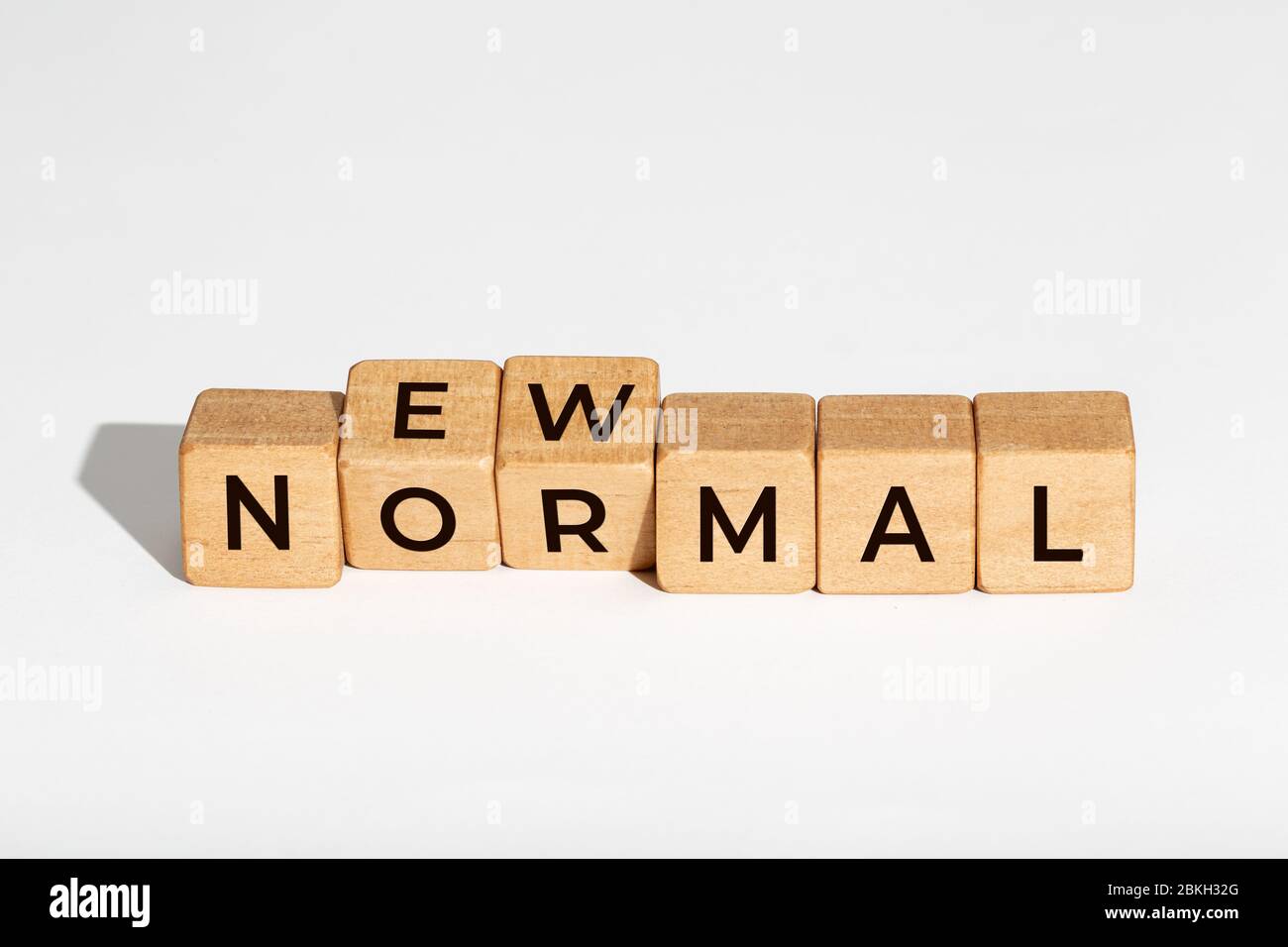 New Normal concept. Wooden dices with text isolated on white background. Copy space Stock Photo