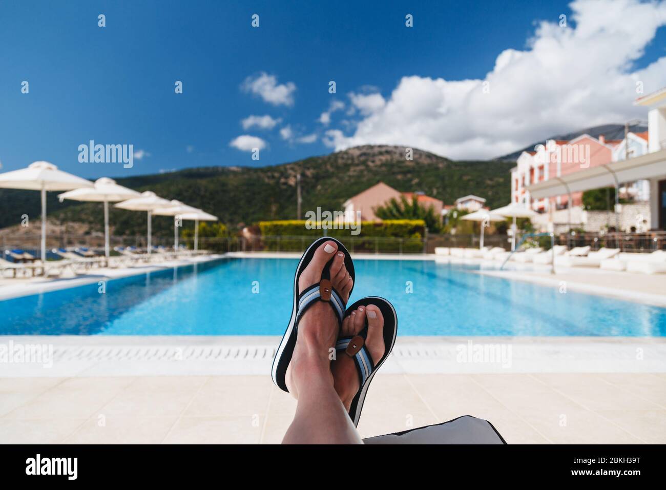 Odyssey Hotel, Agia Efimia, Cephalonia island, Greece - July, 14 2019:  Close up view of young woman feet in Tommy Hilfiger blue flip-flops lying  on a Stock Photo - Alamy