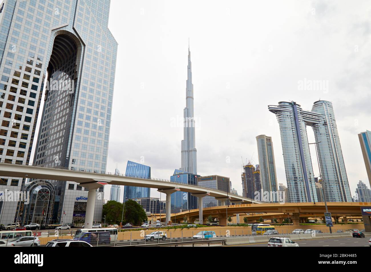DUBAI, UNITED ARAB EMIRATES - NOVEMBER 21, 2019: Burj Khalifa skyscraper, modern buildings, flyover and streets in a cloudy day in Dubai Stock Photo